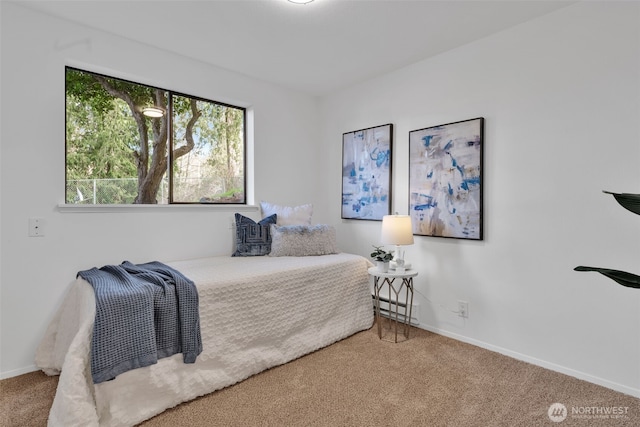 bedroom featuring carpet and baseboards