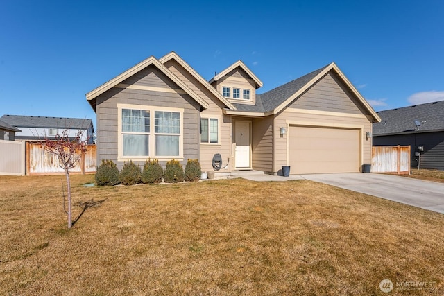 view of front of property featuring a front lawn, fence, driveway, and an attached garage