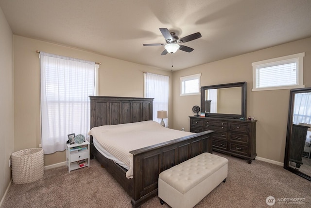 bedroom featuring baseboards, ceiling fan, and light colored carpet