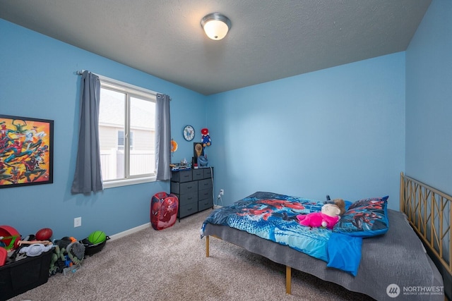 bedroom featuring carpet and a textured ceiling