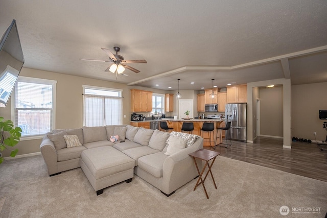 living room featuring light carpet, ceiling fan, baseboards, and recessed lighting