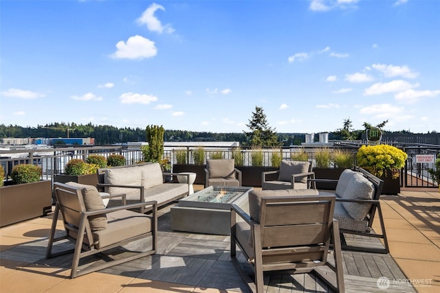 view of patio featuring an outdoor living space with a fire pit