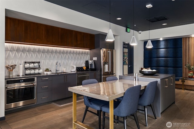 kitchen with modern cabinets, visible vents, stainless steel appliances, and a sink