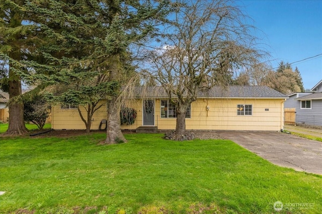 single story home with driveway, a front lawn, and fence