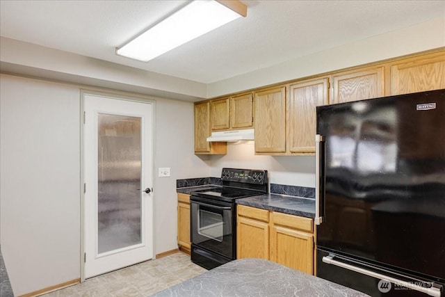 kitchen featuring black appliances, dark countertops, and under cabinet range hood