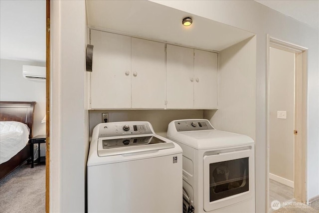 clothes washing area featuring an AC wall unit, cabinet space, independent washer and dryer, and light carpet