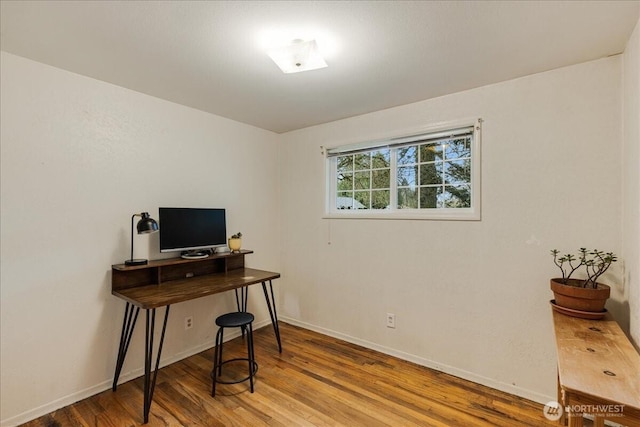 home office featuring wood finished floors and baseboards