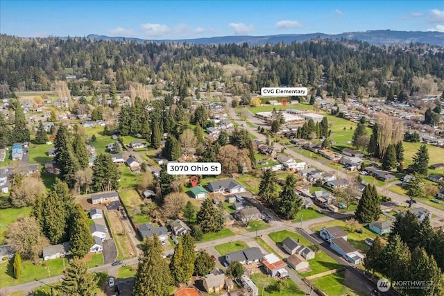 drone / aerial view with a residential view and a wooded view