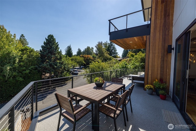 balcony with outdoor dining area and an outdoor hangout area