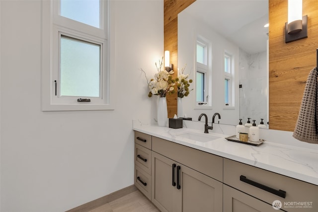 bathroom with vanity and a shower