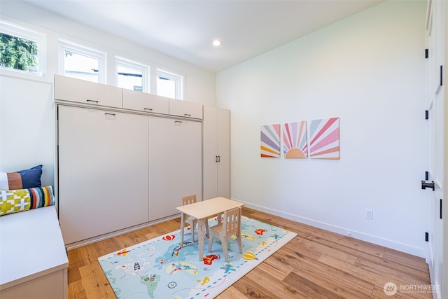 game room with recessed lighting, a healthy amount of sunlight, baseboards, and light wood finished floors