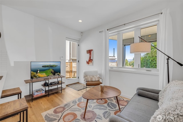 living room featuring recessed lighting, wood finished floors, and baseboards