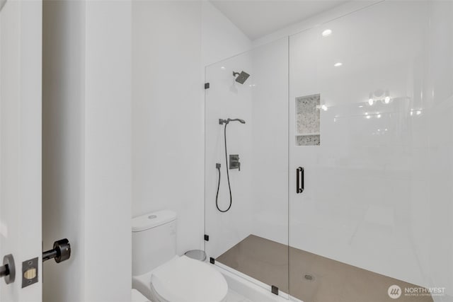 full bathroom featuring toilet and a stall shower