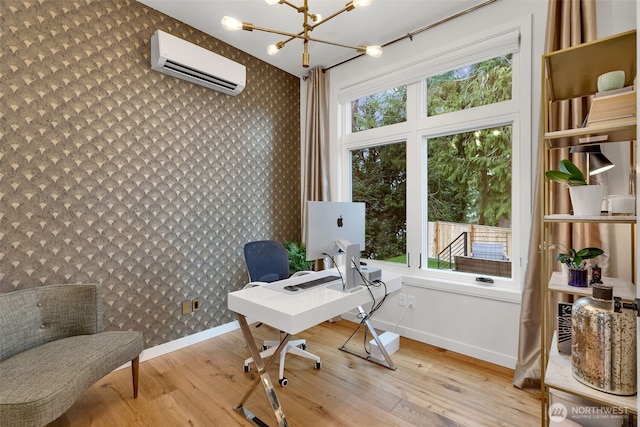 home office featuring wallpapered walls, an inviting chandelier, a wealth of natural light, and a wall mounted AC