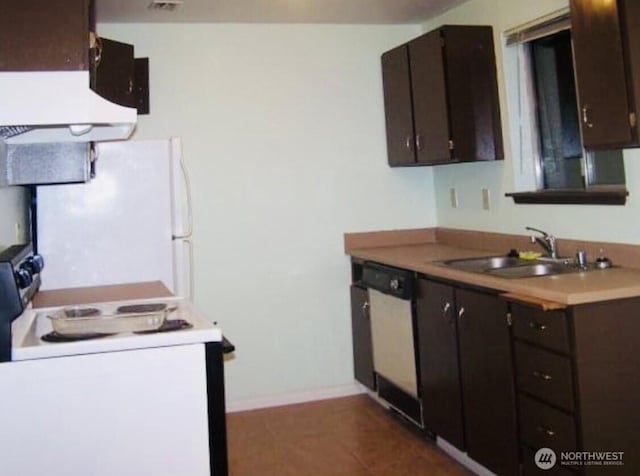 kitchen featuring white appliances, baseboards, light countertops, dark brown cabinets, and a sink