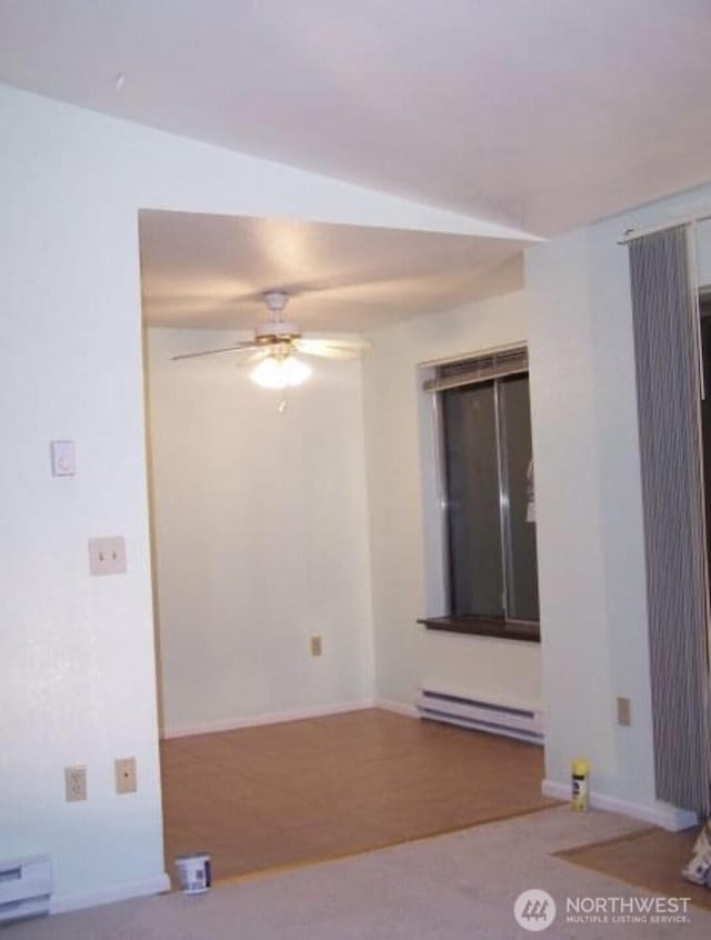 spare room featuring a baseboard heating unit, a baseboard radiator, a ceiling fan, and baseboards