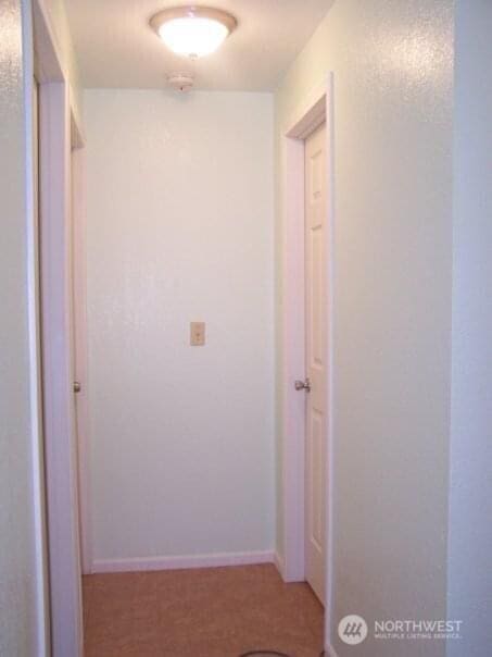 hall featuring baseboards