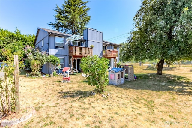 view of play area featuring a lawn and a wooden deck