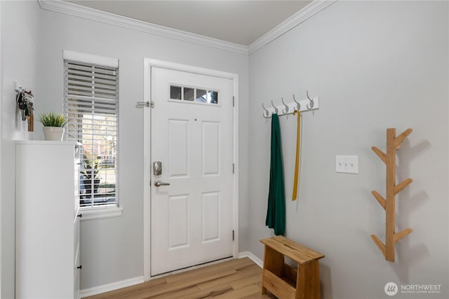 entryway with light wood-style flooring, baseboards, and crown molding