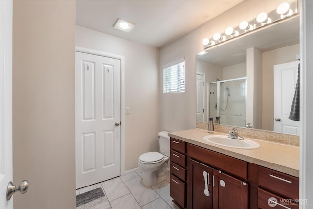 full bathroom featuring a stall shower, vanity, and toilet