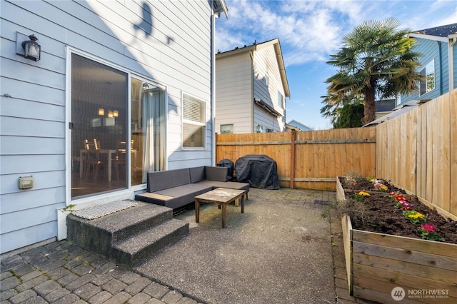 view of patio with a grill, a garden, and fence