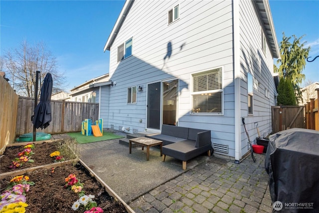 back of property with a patio area, a fenced backyard, and a garden