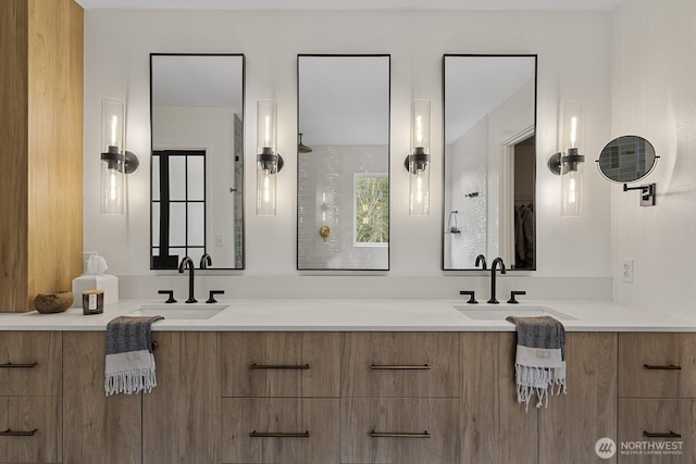 bathroom featuring a sink and double vanity