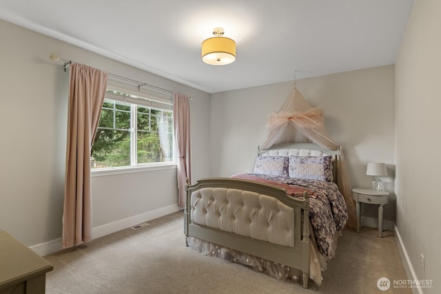 carpeted bedroom with visible vents and baseboards