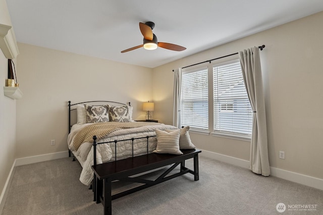 bedroom featuring light carpet, baseboards, and a ceiling fan