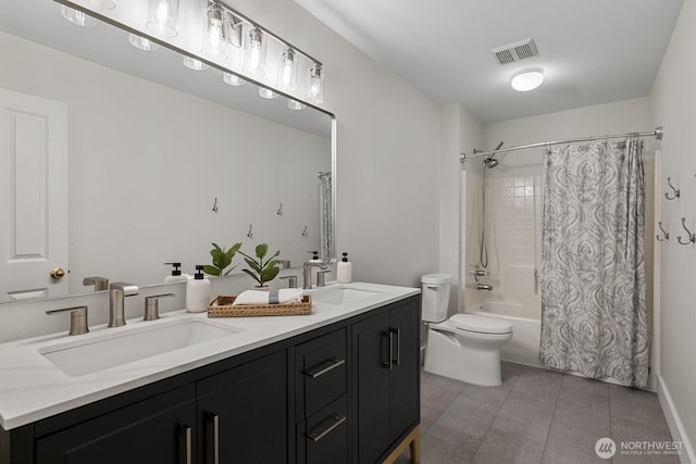 full bath featuring toilet, tile patterned flooring, visible vents, and a sink