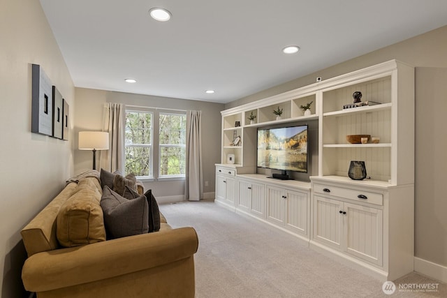 living area featuring recessed lighting, baseboards, and light colored carpet