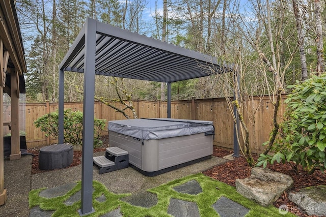 exterior space featuring a pergola, a fenced backyard, and a hot tub