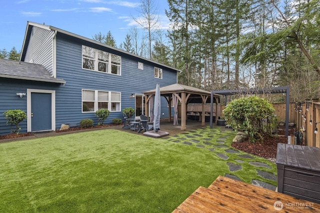 back of house with a gazebo, a yard, a patio, and fence