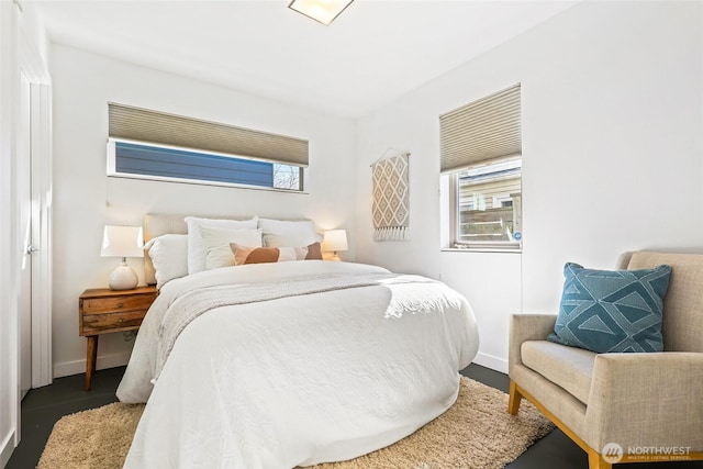 bedroom with baseboards and wood finished floors