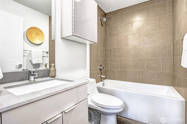 full bathroom featuring washtub / shower combination, vanity, and toilet