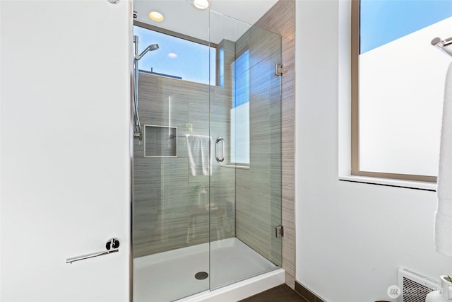 full bath with a shower stall and visible vents