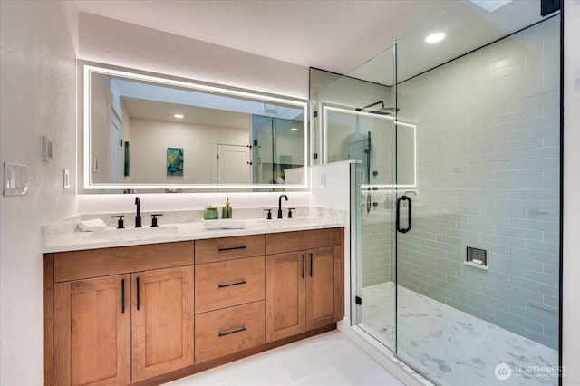 full bath with tile patterned flooring, a sink, a shower stall, and double vanity