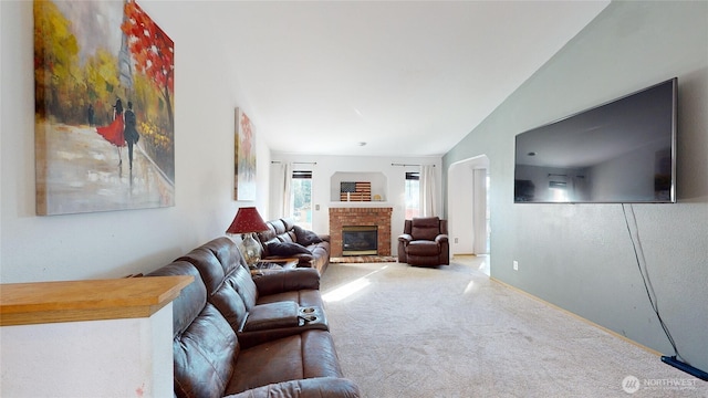 living area featuring carpet, a fireplace, and lofted ceiling