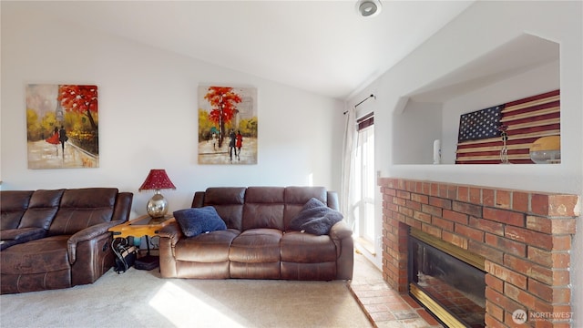 living room featuring lofted ceiling, a brick fireplace, and carpet