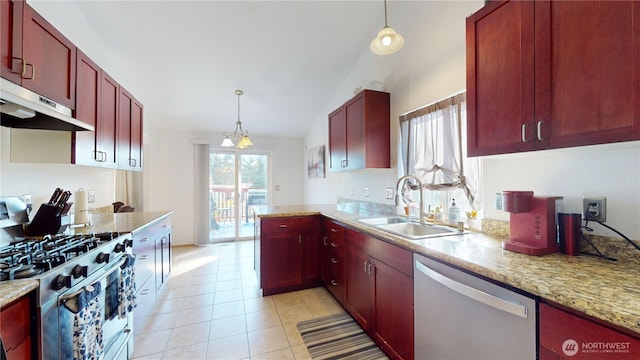 kitchen featuring under cabinet range hood, a sink, dark brown cabinets, appliances with stainless steel finishes, and decorative light fixtures