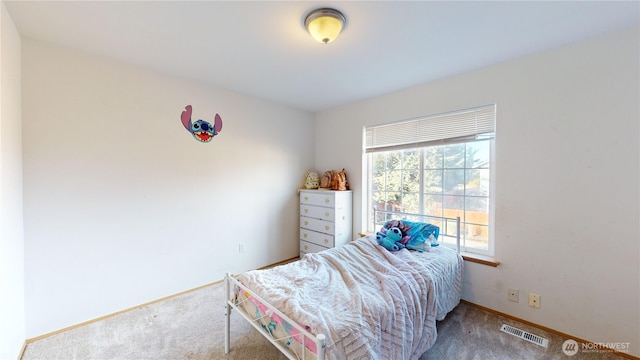 bedroom featuring carpet floors, visible vents, and baseboards