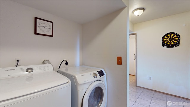 laundry room with light tile patterned floors, baseboards, and separate washer and dryer