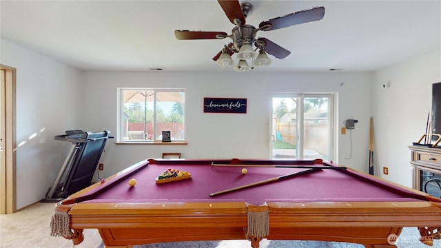 recreation room featuring carpet, plenty of natural light, visible vents, and a ceiling fan