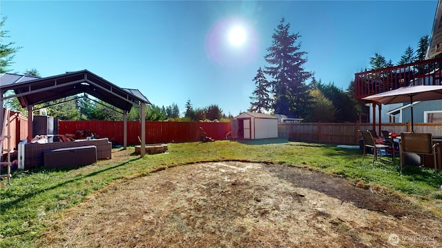 view of yard with a storage unit, an outdoor structure, and a fenced backyard