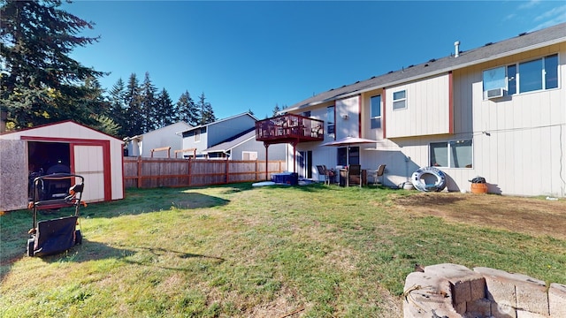 view of yard with a shed, a residential view, fence, and an outdoor structure