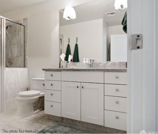 full bathroom featuring visible vents, a stall shower, vanity, and toilet