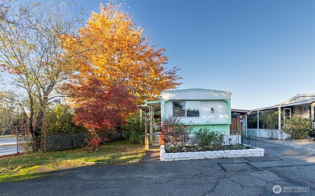 view of front of home featuring fence