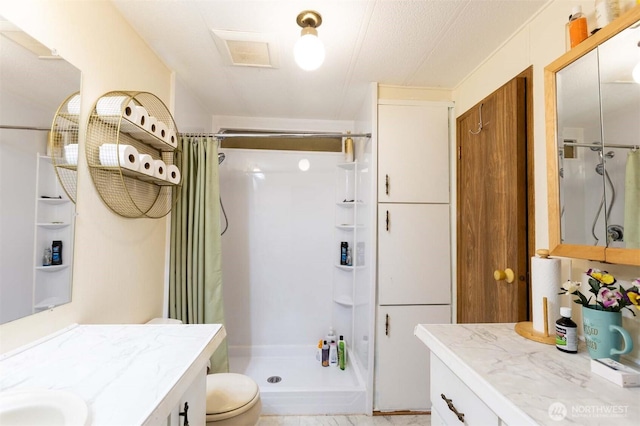 full bathroom featuring toilet, a shower stall, and vanity