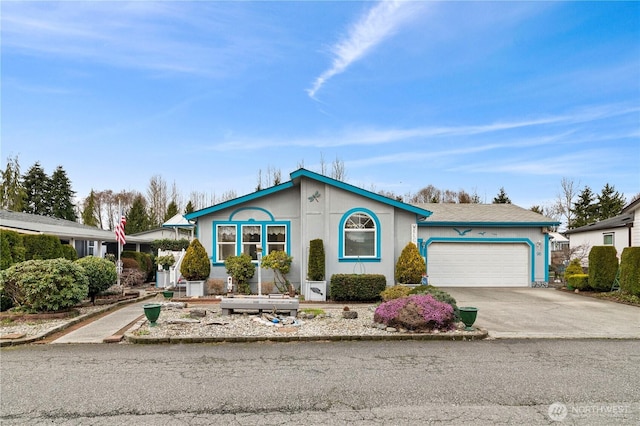 view of front of property featuring concrete driveway and a garage