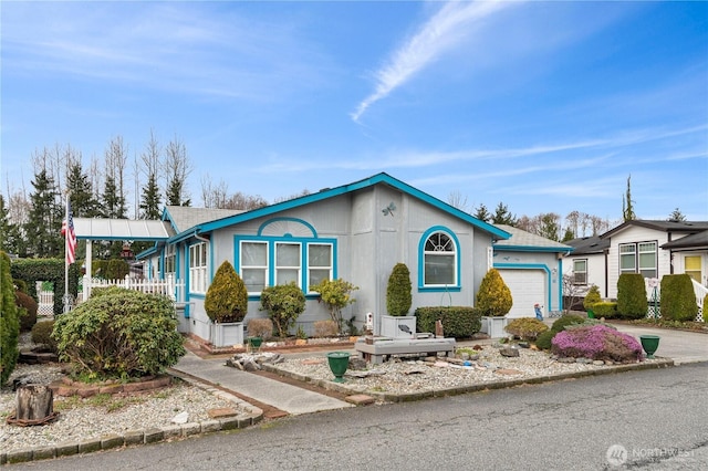 view of front of property with concrete driveway and a garage